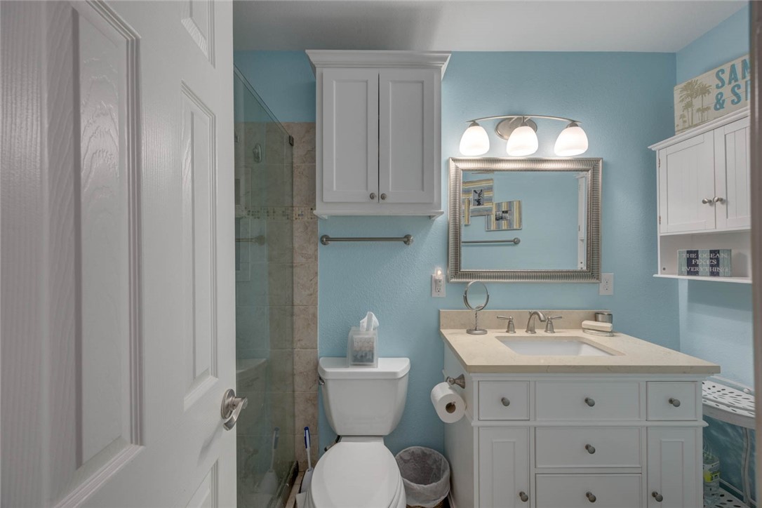 2290 North Fulton Beach Road, Unit 315 Rockport, TX 78382 - Photo 12 of 25 a bathroom with a toilet a sink and mirror