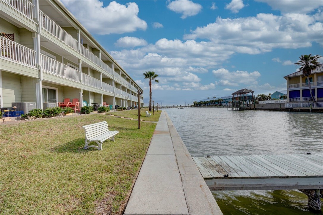 2290 North Fulton Beach Road, Unit 315 Rockport, TX 78382 - Photo 22 of 25 a view of a lake with a building and trees in the background