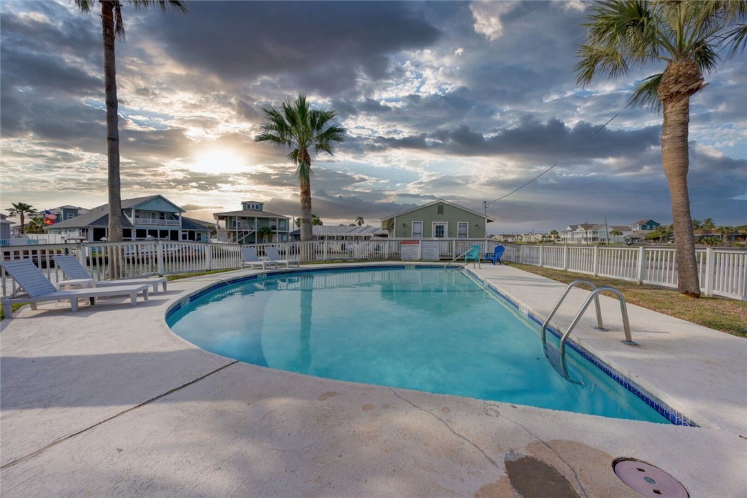 2290 North Fulton Beach Road, Unit 315 Rockport, TX 78382 - Photo 23 of 25 a view of a swimming pool with a lounge chair