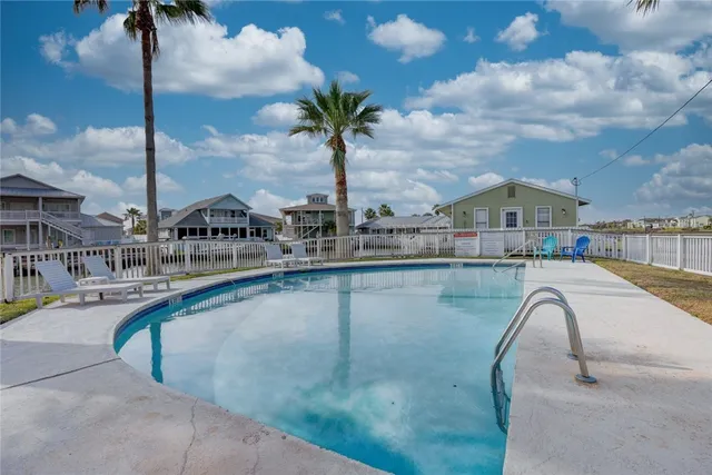a swimming pool with outdoor seating