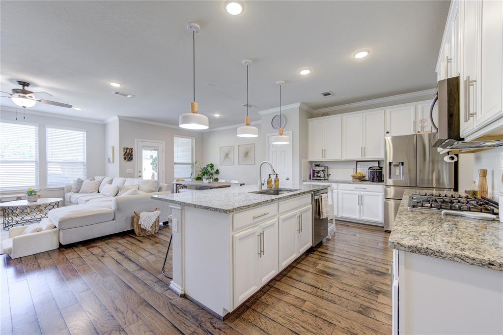a large kitchen with kitchen island lots of counter space a sink appliances and cabinets