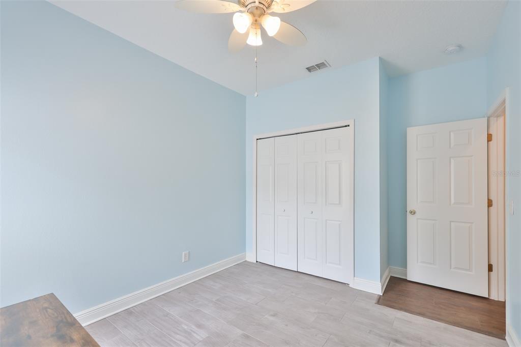 708 Coade Stone Drive Seffner, FL 33584 - Photo 23 of 48 an empty room with wooden floor closet and windows
