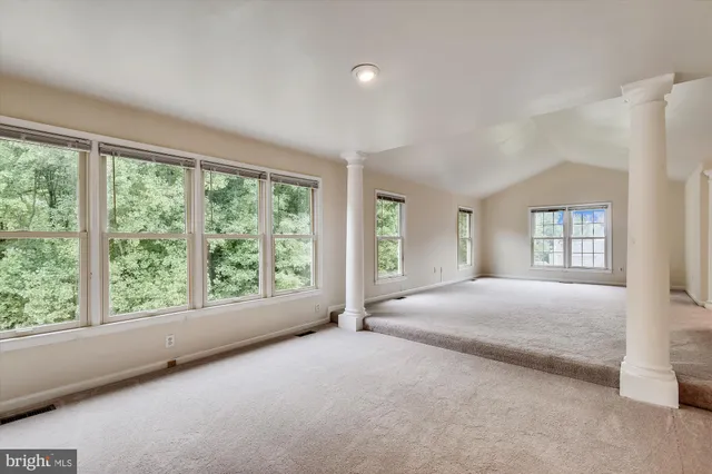 a bed room with a bed and a large window