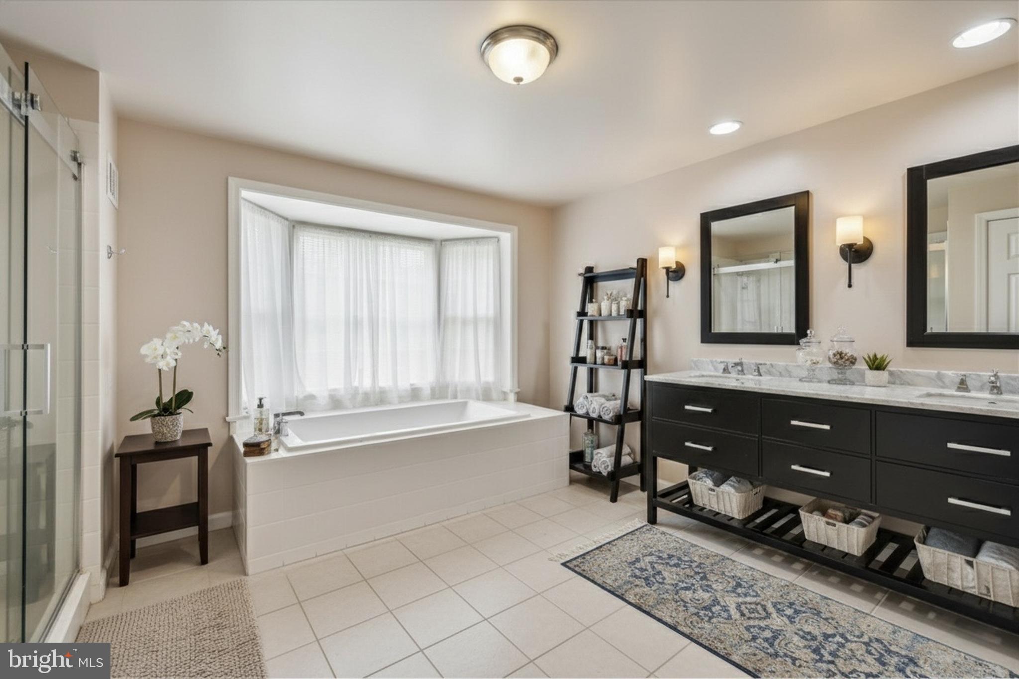 9715 Middleton Ridge Road Vienna, VA 22182 - Photo 14 of 30 a spacious bathroom with a double vanity sink and a mirror