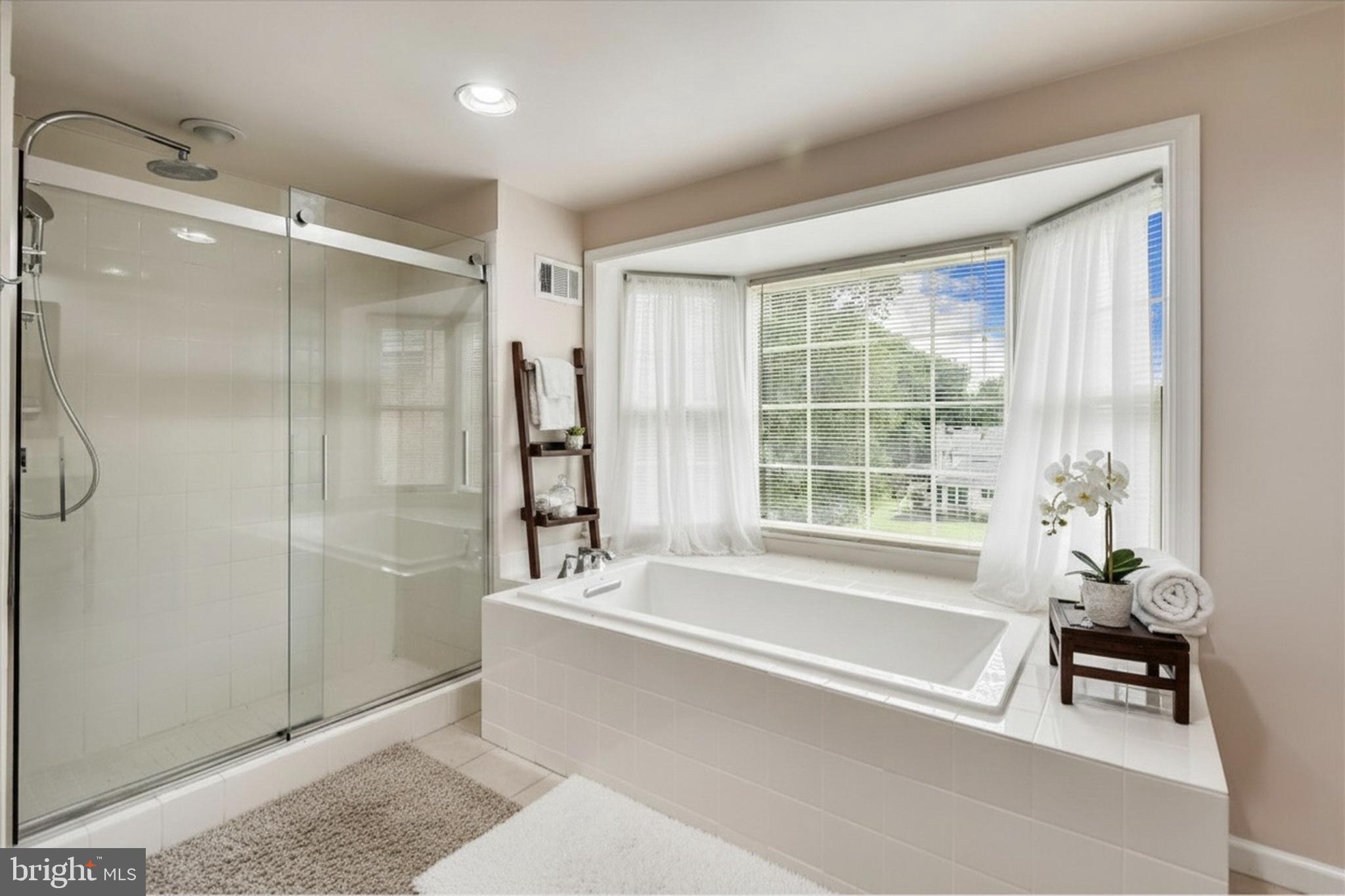 9715 Middleton Ridge Road Vienna, VA 22182 - Photo 15 of 30 a spacious bathroom with a bathtub and a shower