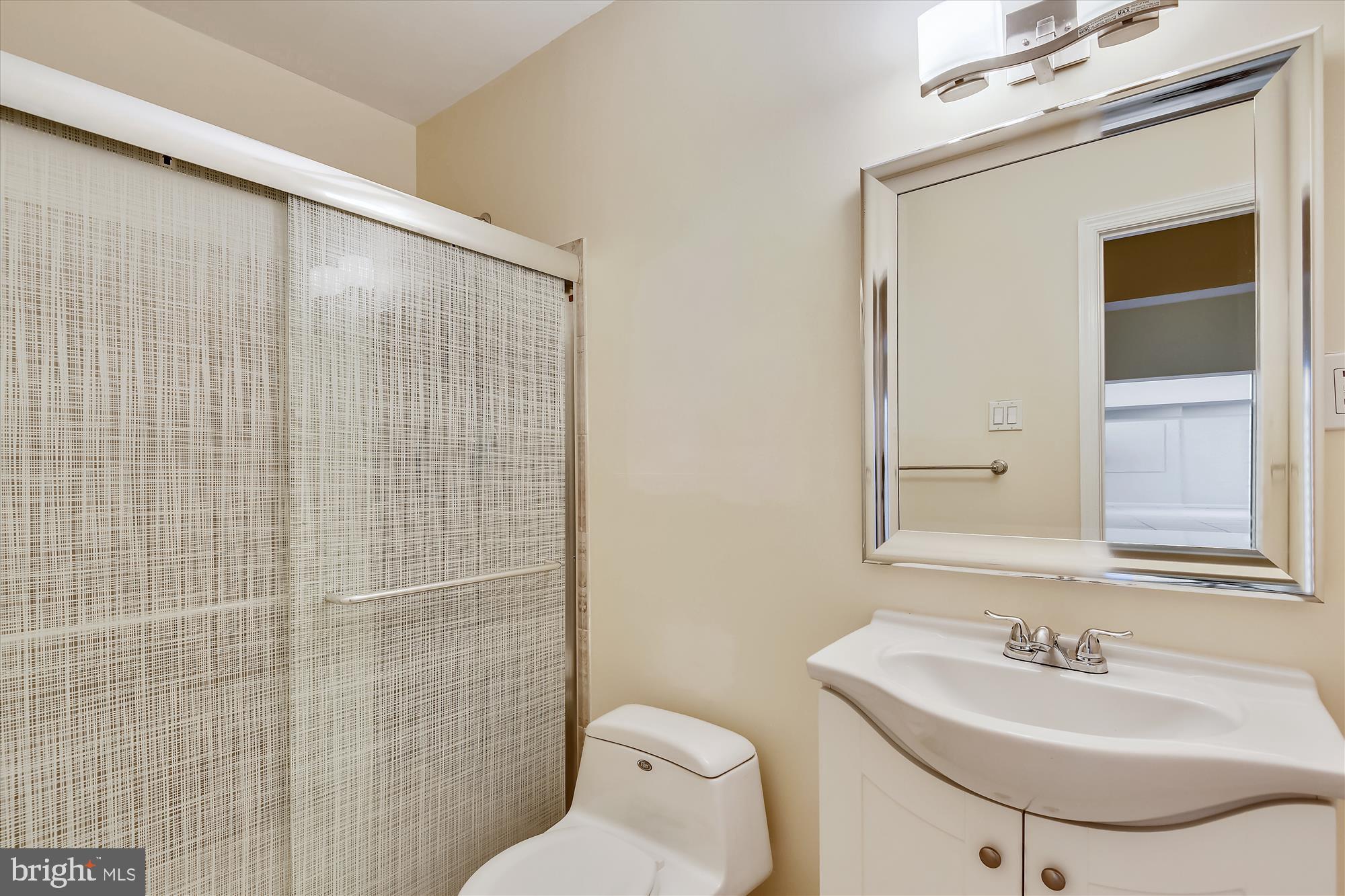 9715 Middleton Ridge Road Vienna, VA 22182 - Photo 16 of 29 a bathroom with a sink toilet and mirror