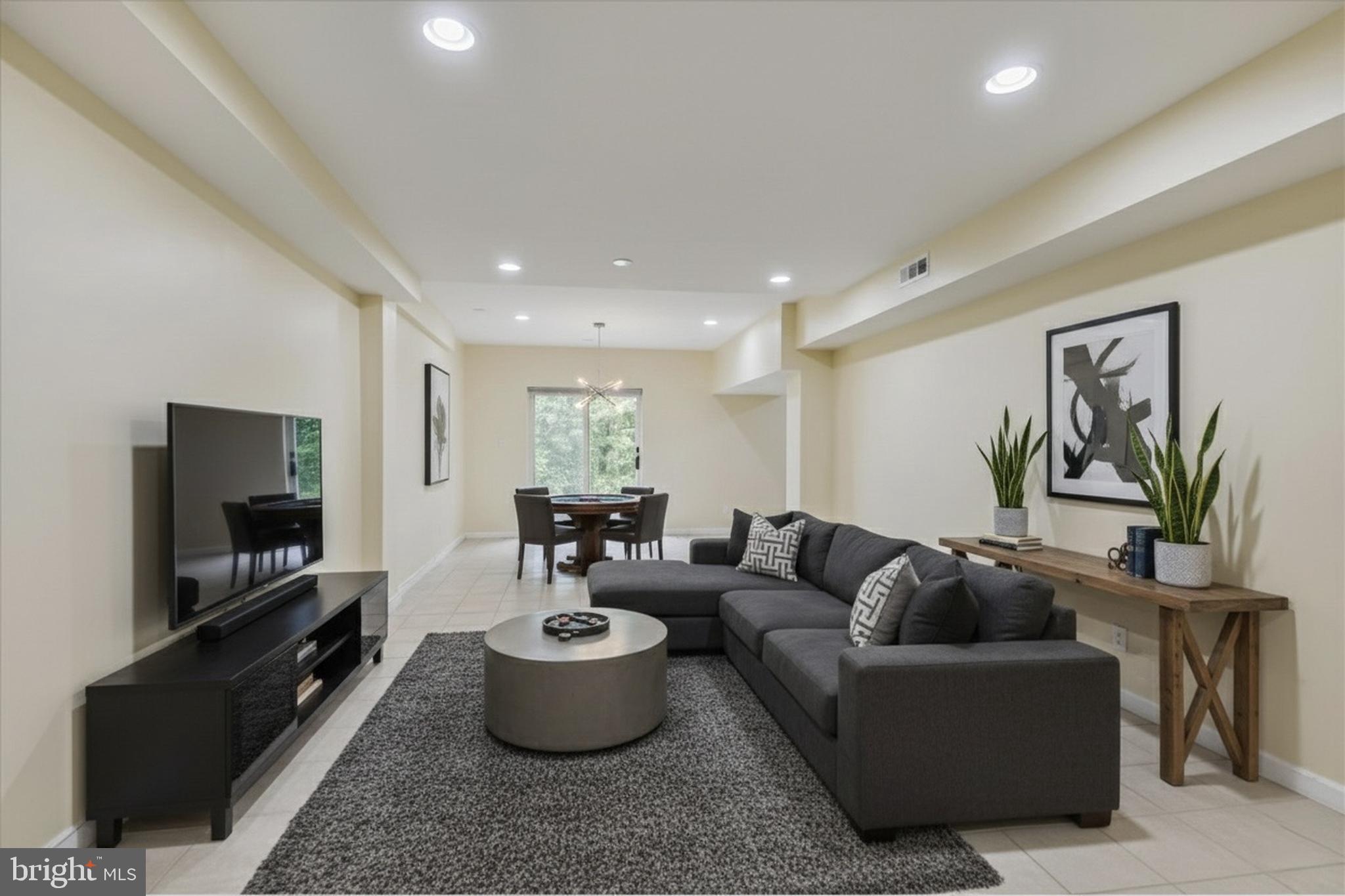 9715 Middleton Ridge Road Vienna, VA 22182 - Photo 21 of 30 a living room with furniture and a flat screen tv