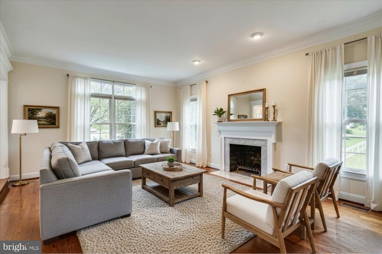 9715 Middleton Ridge Road Vienna, VA 22182 - Photo 6 of 30 a living room with furniture and a fireplace