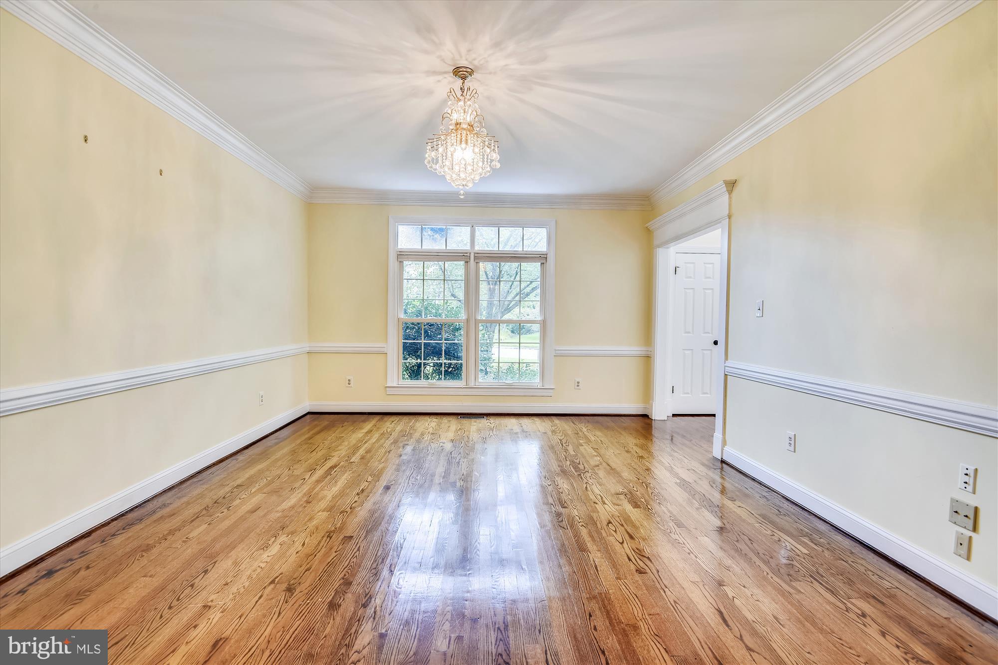 9715 Middleton Ridge Road Vienna, VA 22182 - Photo 6 of 29 a view of an empty room with wooden floor and a window