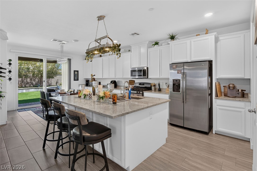 1824 Redland Ridge Street Henderson, NV 89002 - Photo 2 of 69 Culinary aspirations meet effortless entertaining in this kitchen, boasting an island for gatherings and direct patio access.