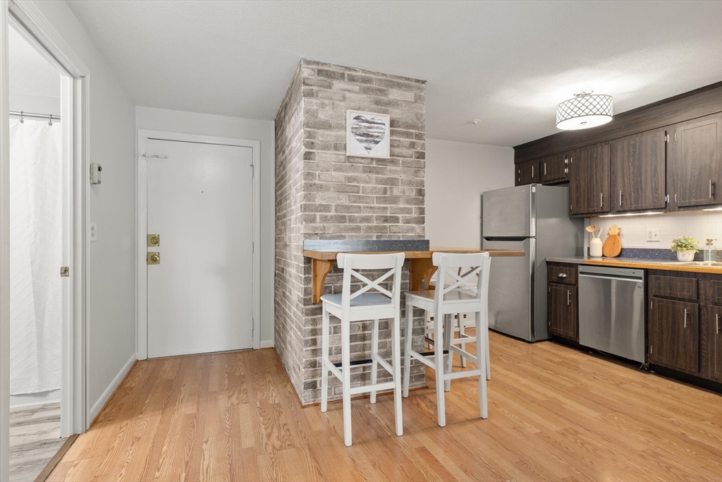 96 Richardson Road, Unit B23 North Chelmsford, MA 01863 - Photo 15 of 31 a kitchen with a table and chairs in it