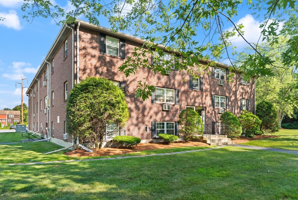 96 Richardson Road, Unit B23 North Chelmsford, MA 01863 - Photo 2 of 31 a front view of a house with a yard