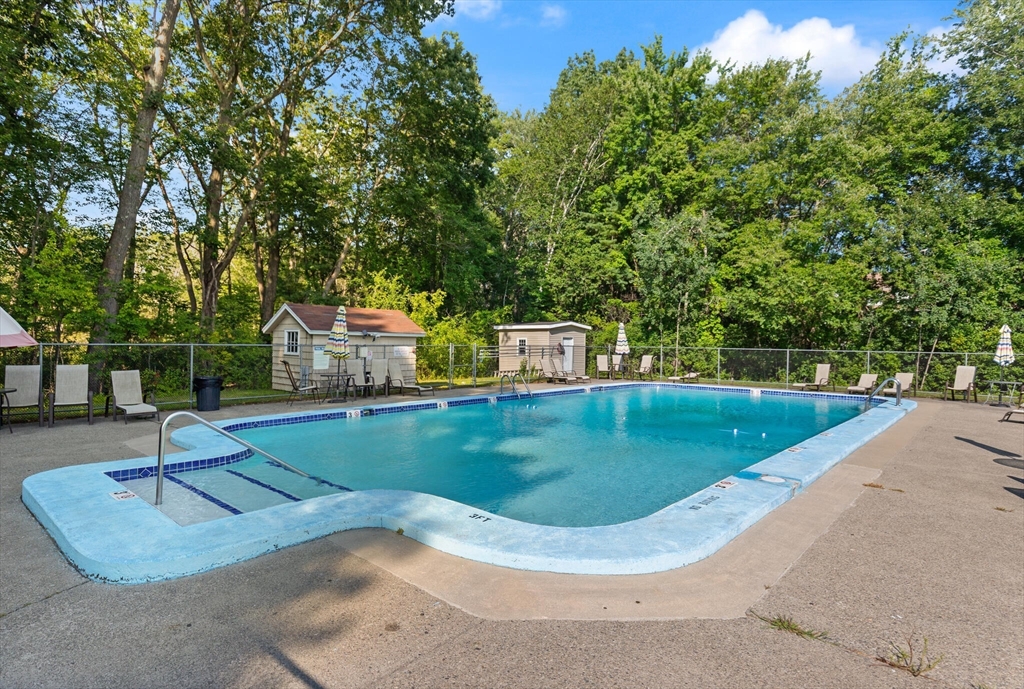 96 Richardson Road, Unit B23 North Chelmsford, MA 01863 - Photo 24 of 31 a view of a swimming pool with a patio