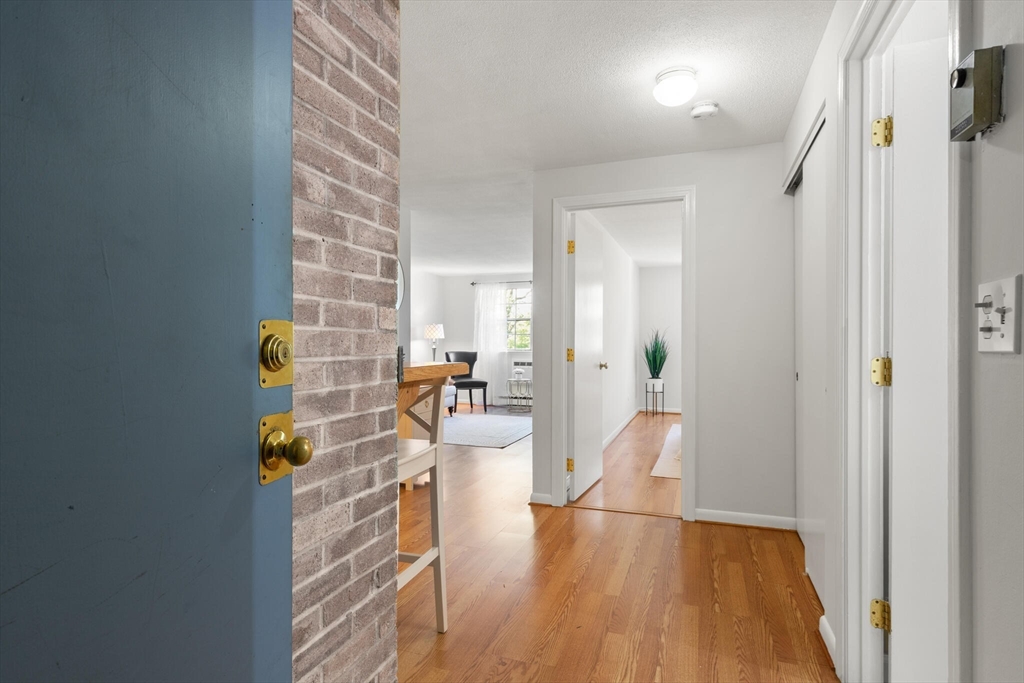 96 Richardson Road, Unit B23 North Chelmsford, MA 01863 - Photo 3 of 31 a view of a hallway and wooden floor with windows