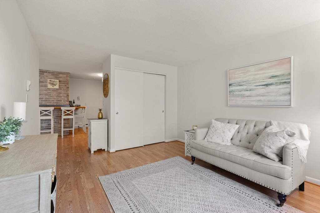 96 Richardson Road, Unit B23 North Chelmsford, MA 01863 - Photo 6 of 31 a living room with furniture and a wooden floor
