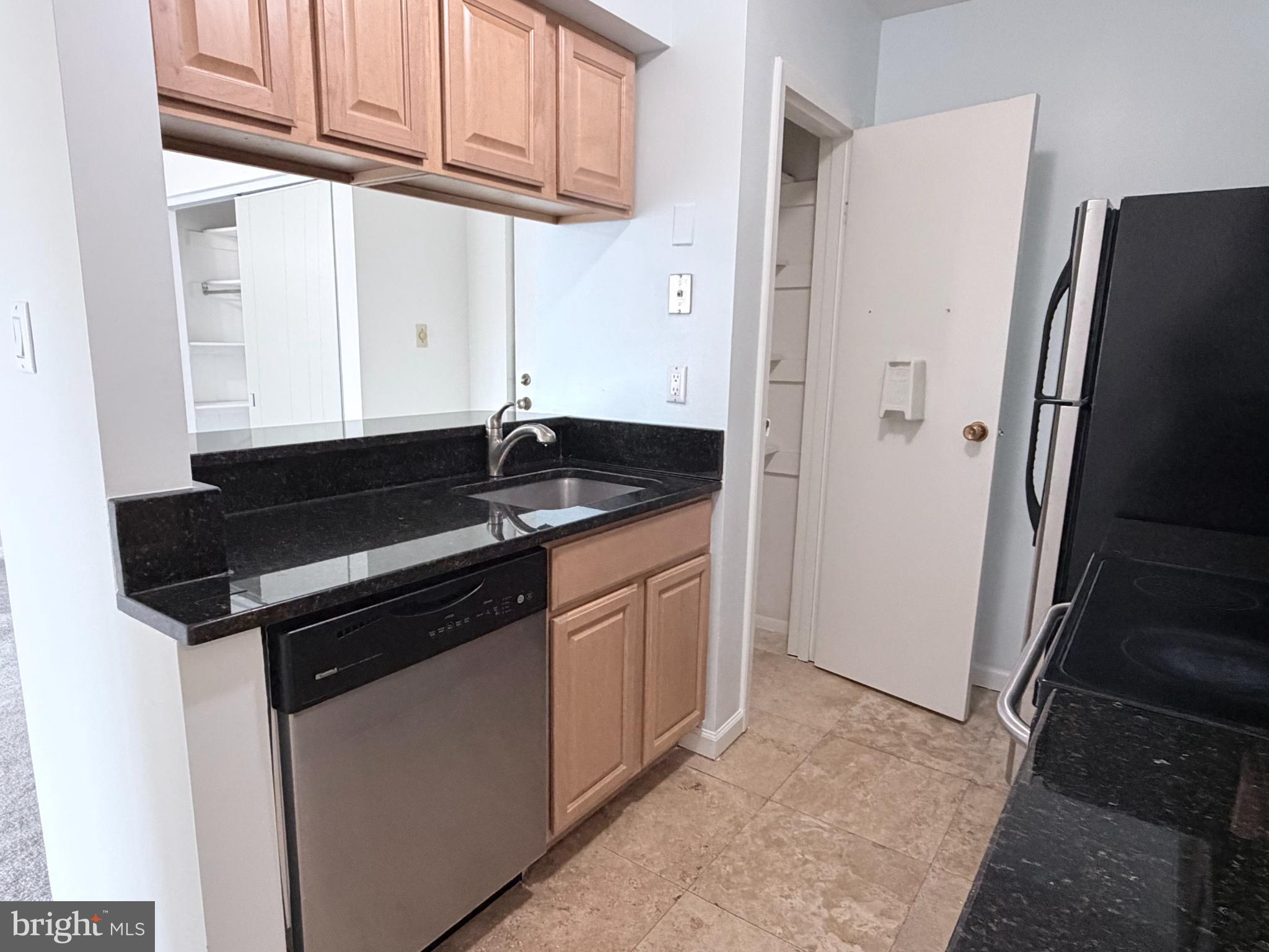 5823 S Royal Ridge Drive Springfield, VA 22152 - Photo 8 of 30 a kitchen with granite countertop a refrigerator and a sink