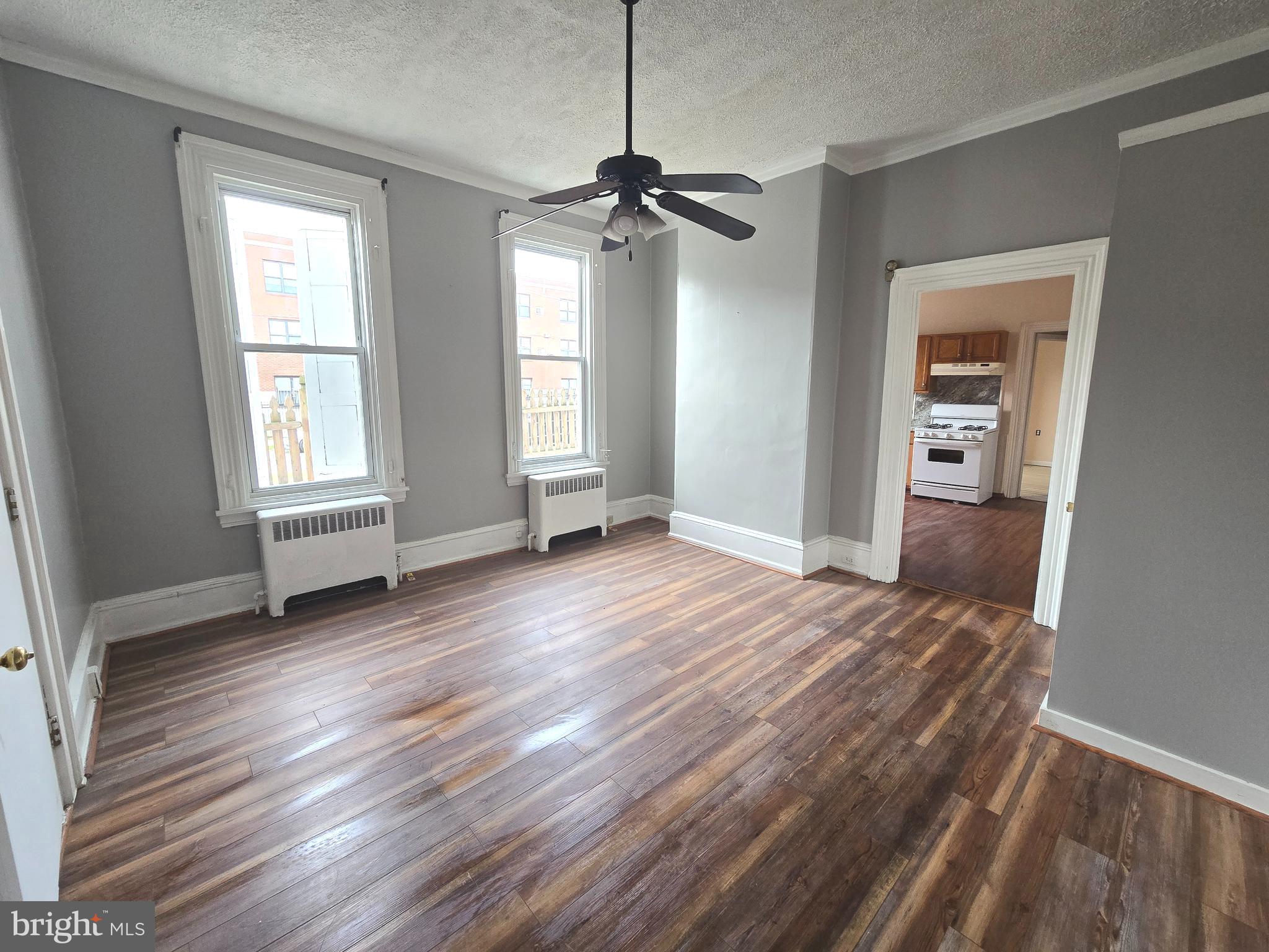 5315 Master Street, Unit 1 Philadelphia, PA 19131 - Photo 1 of 7 a view of a room with wooden floor ceiling fan and windows