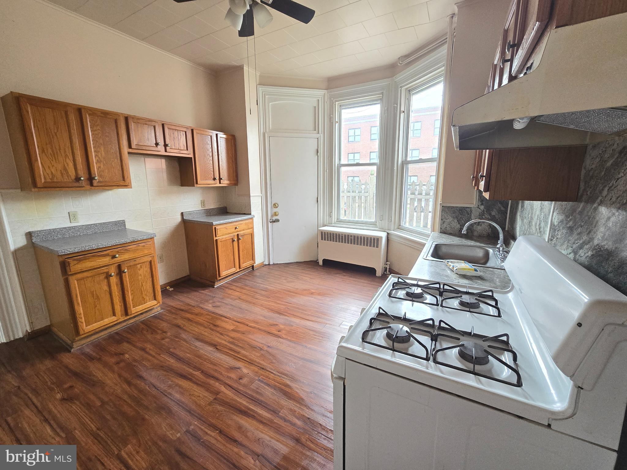 5315 Master Street, Unit 1 Philadelphia, PA 19131 - Photo 2 of 7 a kitchen with a stove and a wooden floors