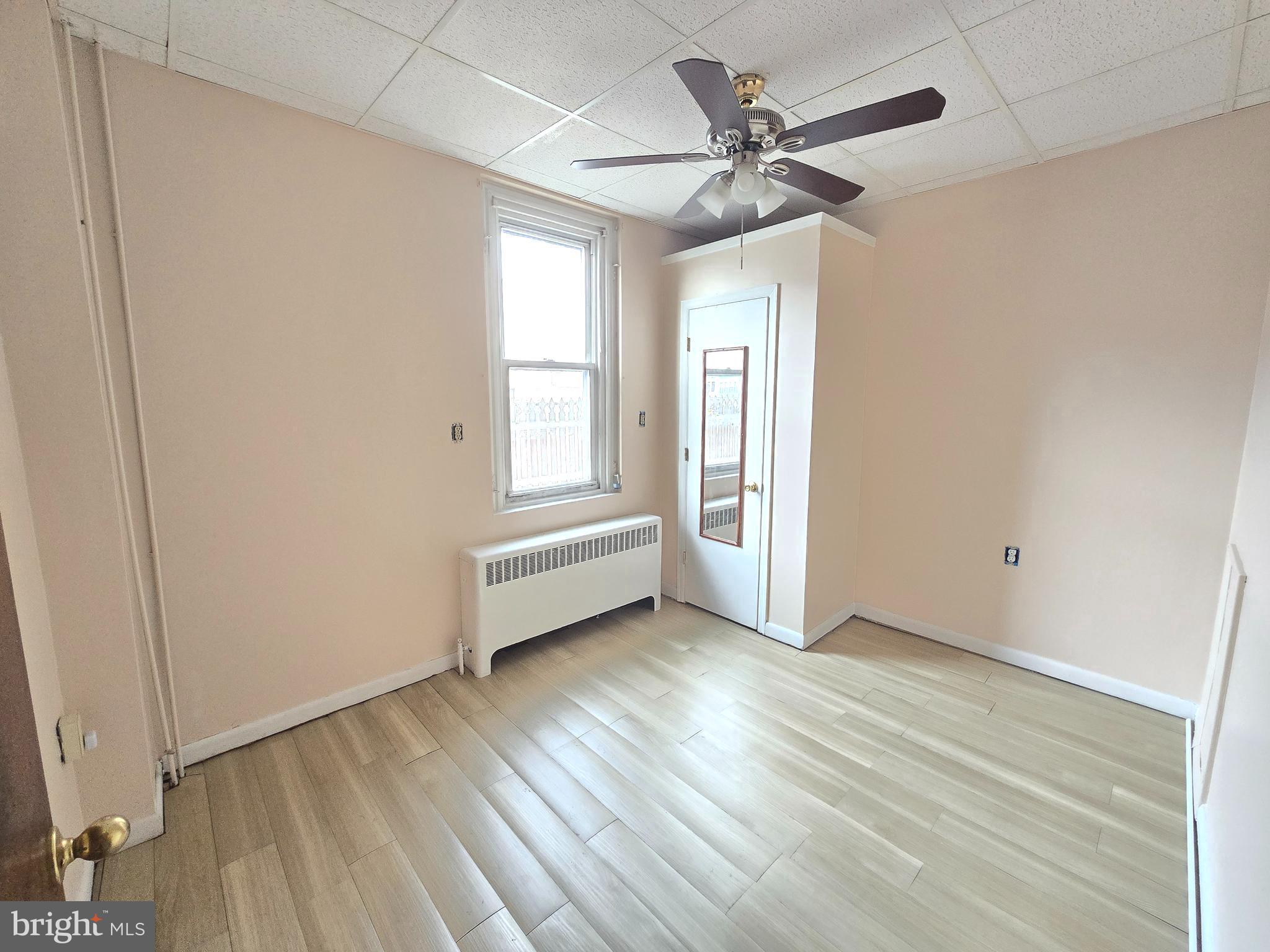5315 Master Street, Unit 1 Philadelphia, PA 19131 - Photo 5 of 7 an empty room with wooden floor ceiling fan and windows