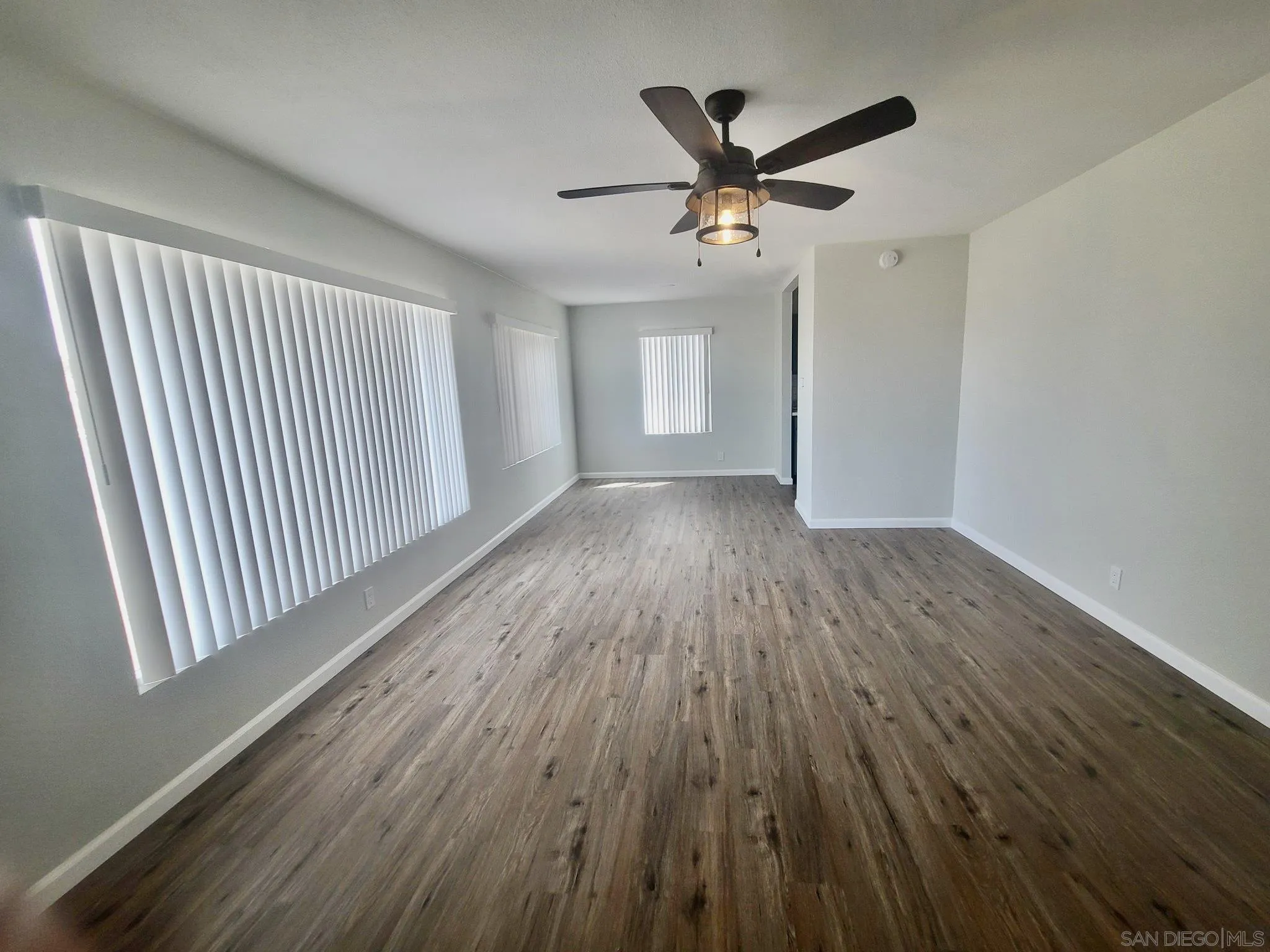 401 North Balsam Street Ridgecrest, CA 93555 - Photo 3 of 23 wooden floor in an empty room with a window