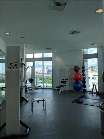 a living room with furniture gaming tables and a large window