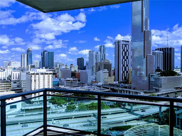 a view of empty room with wooden floor and floor to ceiling window