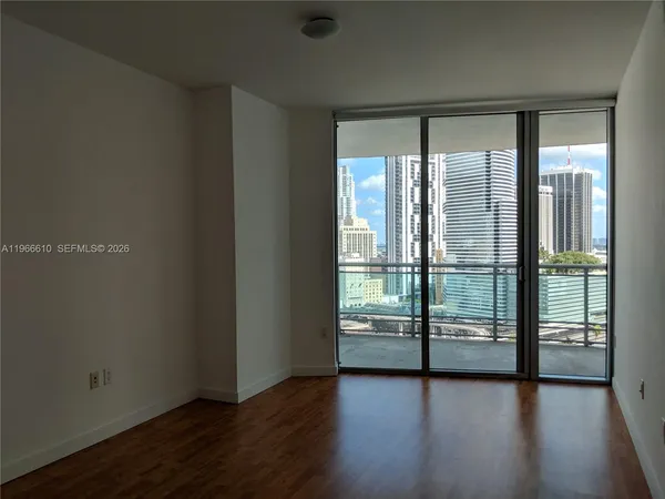 a view of a livingroom with furniture and an empty room