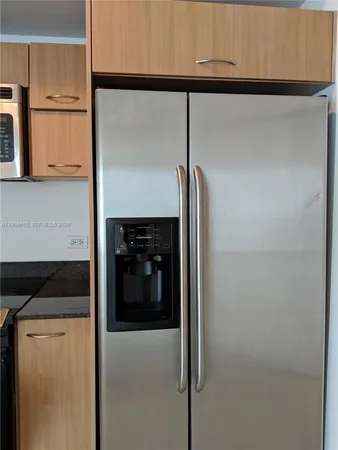 a view of a room with wooden floor and window