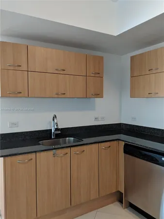 a lobby with furniture and chandelier