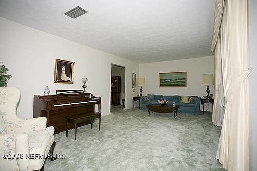 6803 Clifton Forge Road Jacksonville, FL 32277 - Photo 7 of 8 a living room with furniture and a piano