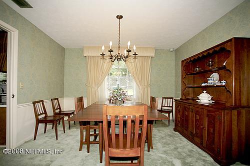 6803 Clifton Forge Road Jacksonville, FL 32277 - Photo 8 of 8 a view of a dining room with furniture and chandelier