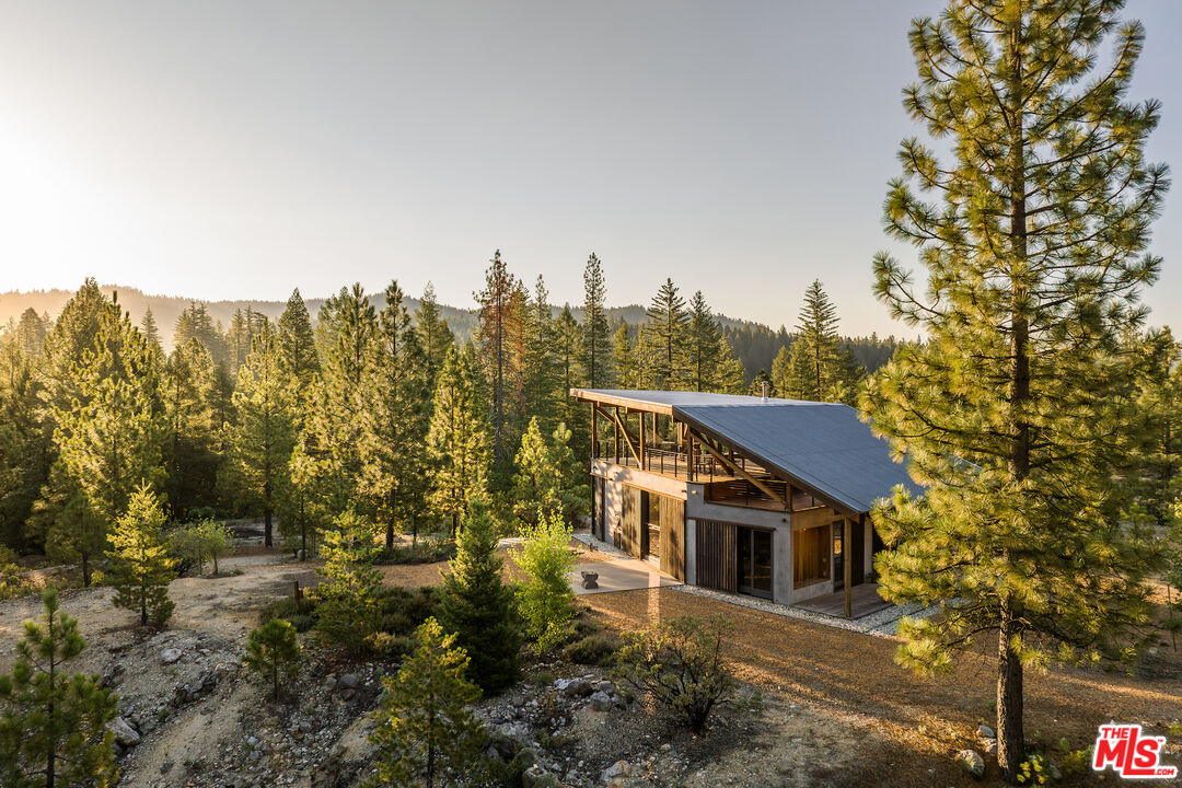 a view of a house with a trees front of it