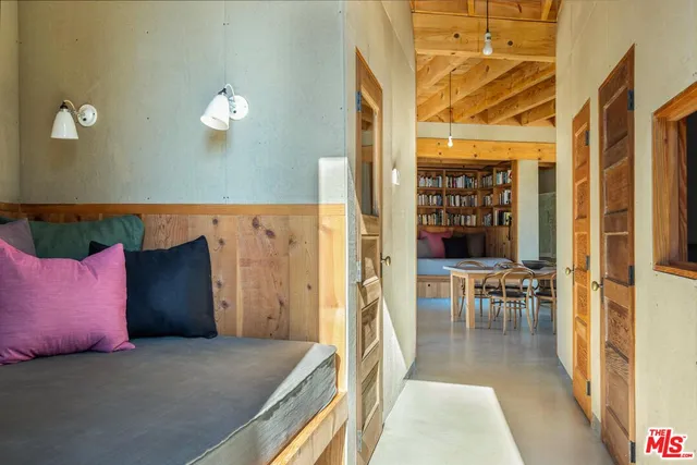 a view of a bedroom with furniture and a window