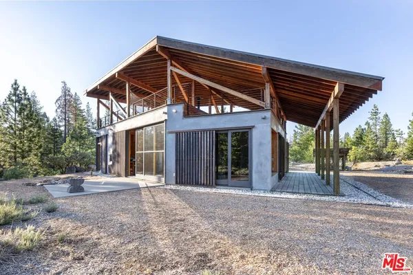 a front view of a house with basket ball court and outdoor seating