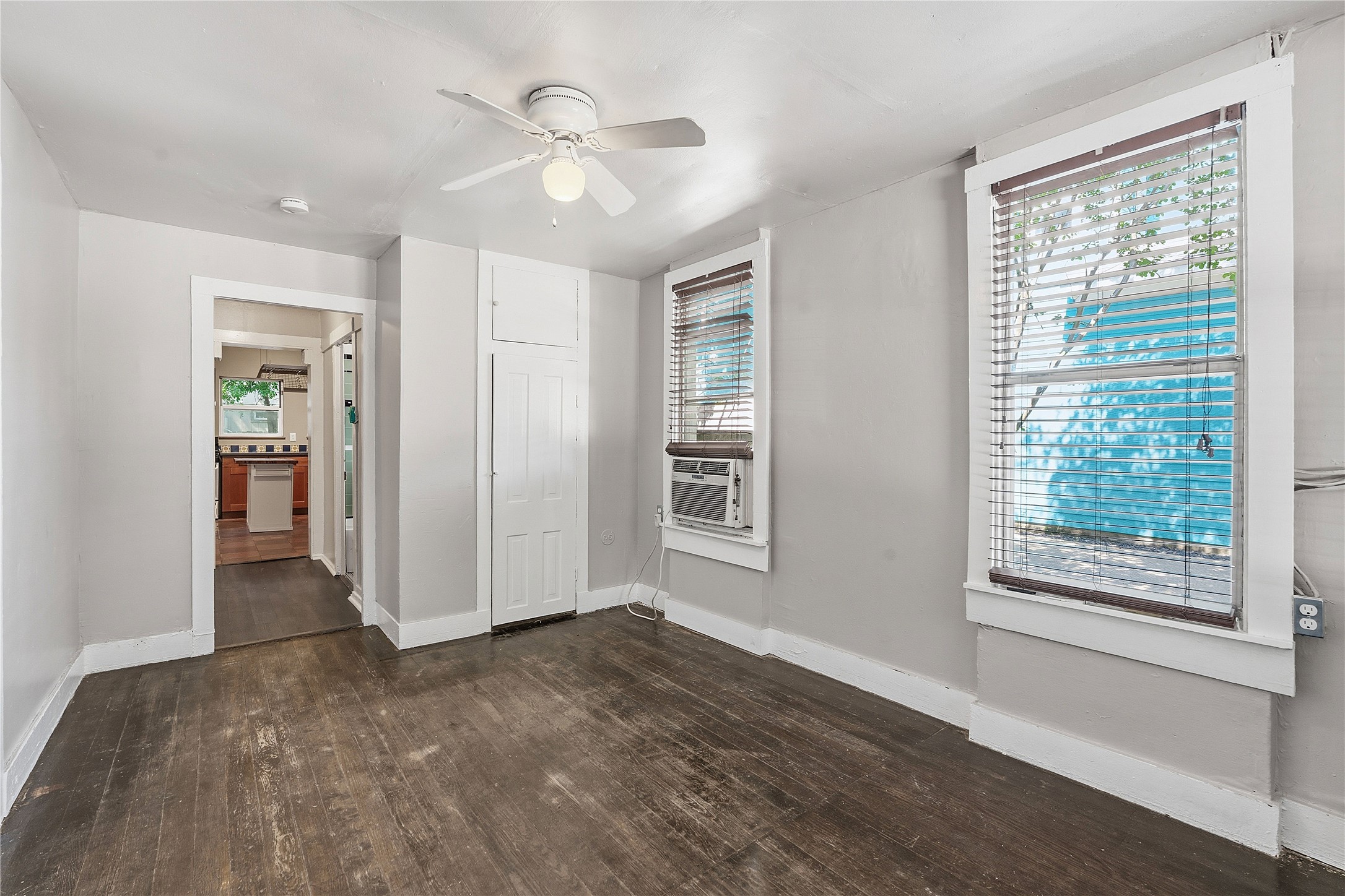 2207 Santa Rita Street Austin, TX 78702 - Photo 7 of 15 Room featuring wood-finish flooring, light gray walls, and white trim
