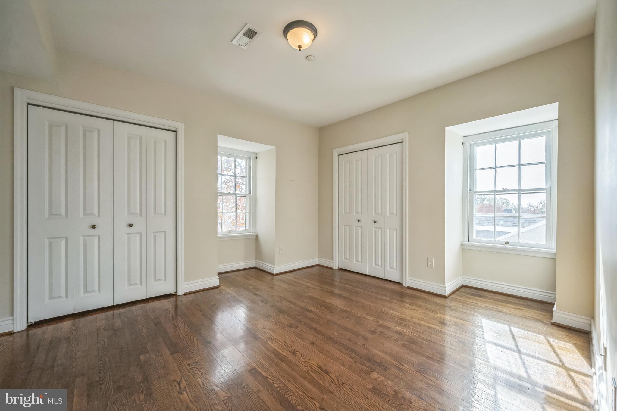 37 South Prospect Street, Unit 401 Hagerstown, MD 21740 - Photo 12 of 15 an empty room with wooden floor and windows