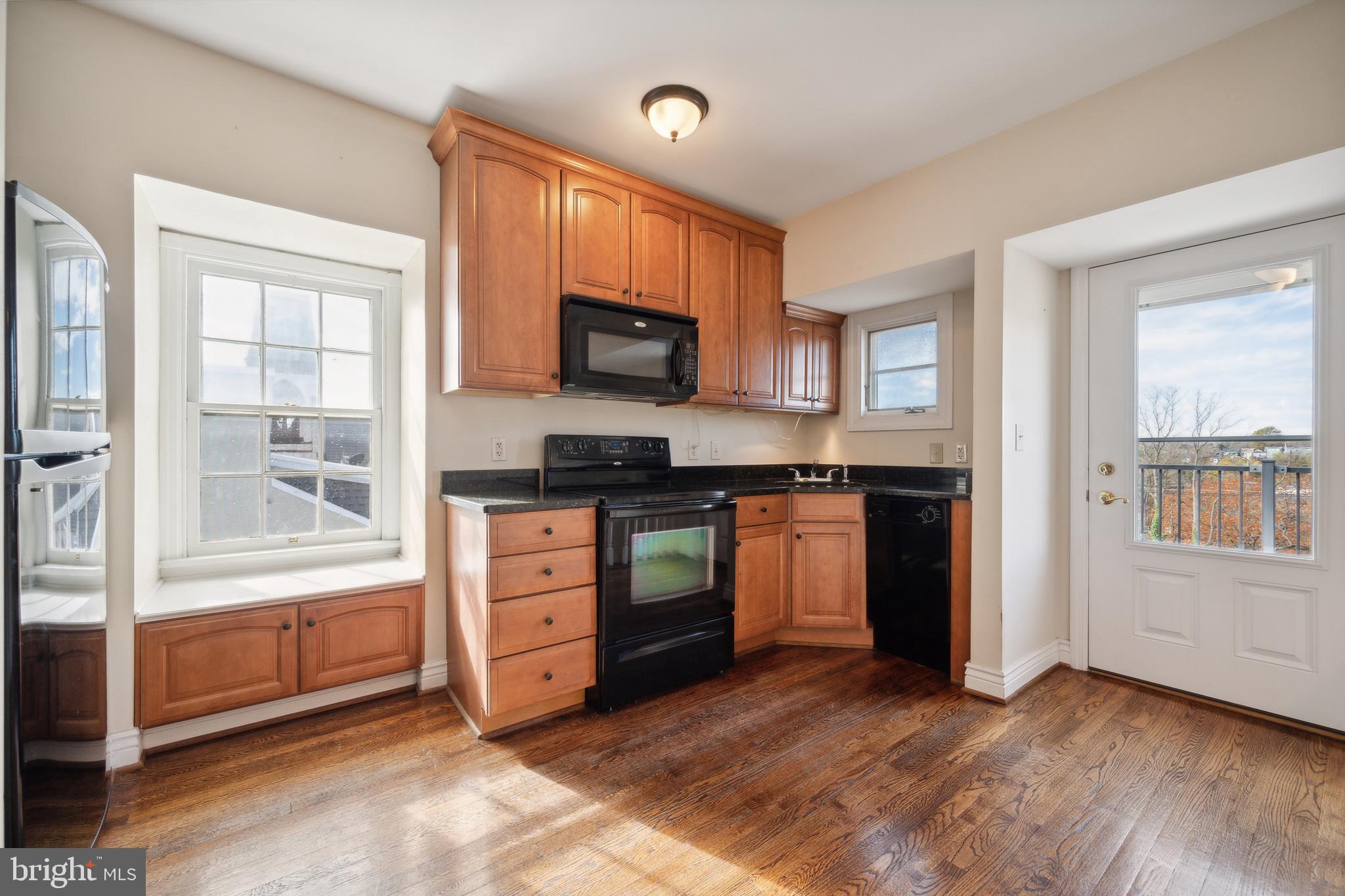 37 South Prospect Street, Unit 401 Hagerstown, MD 21740 - Photo 8 of 15 a kitchen with stainless steel appliances a stove a sink and a microwave