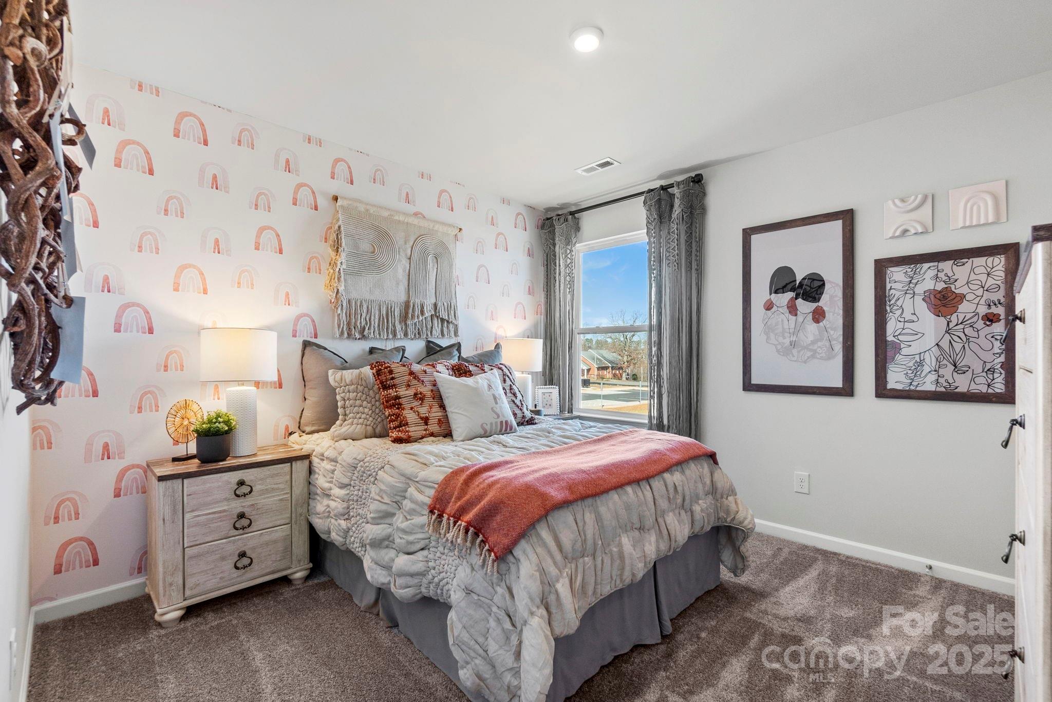 8130 Chilkoot Lane Locust, NC 28097 - Photo 20 of 28 a bedroom with bed and painting on the wall