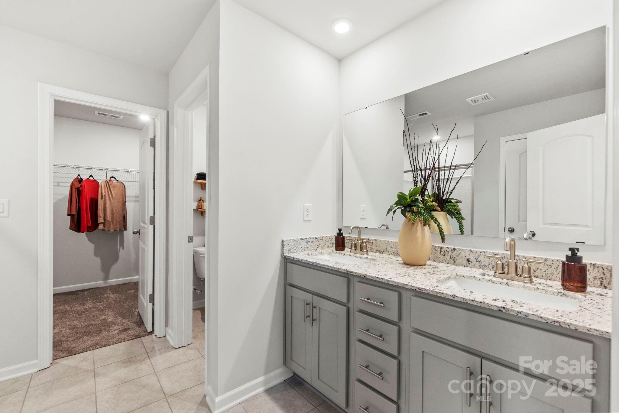 8130 Chilkoot Lane Locust, NC 28097 - Photo 24 of 28 a bathroom with a granite countertop sink and a mirror