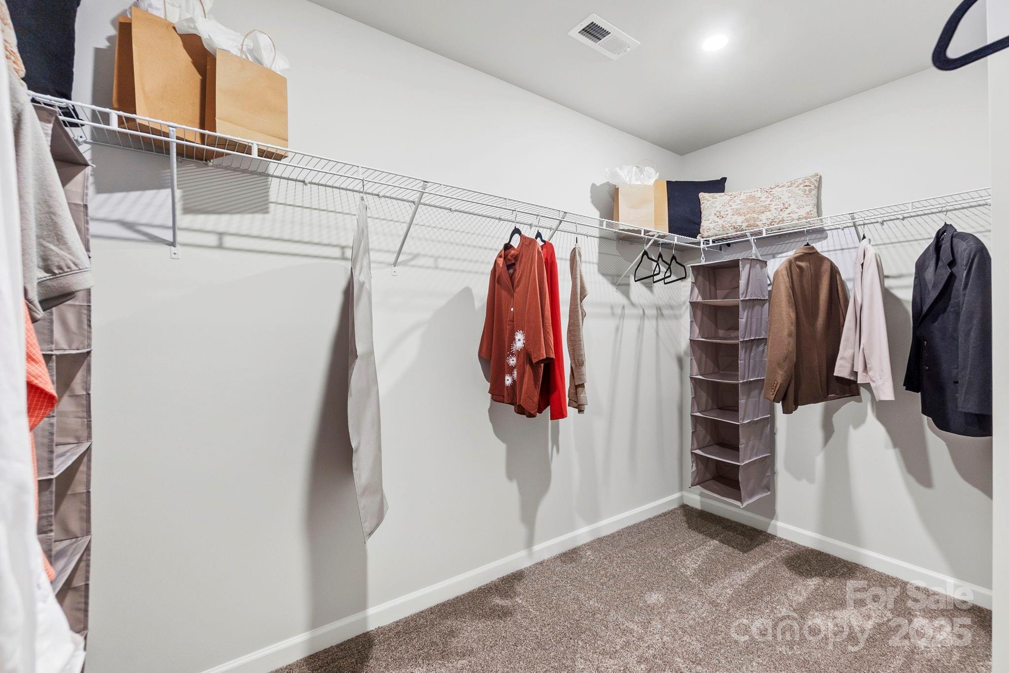 8130 Chilkoot Lane Locust, NC 28097 - Photo 25 of 28 a view of walk in closet with clothes and shoes