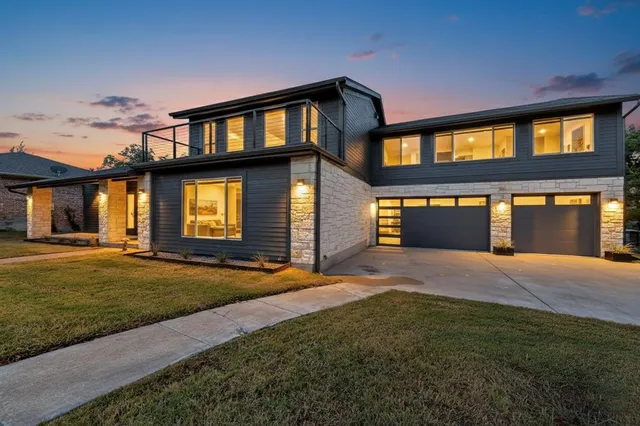 a front view of a house with a yard and garage