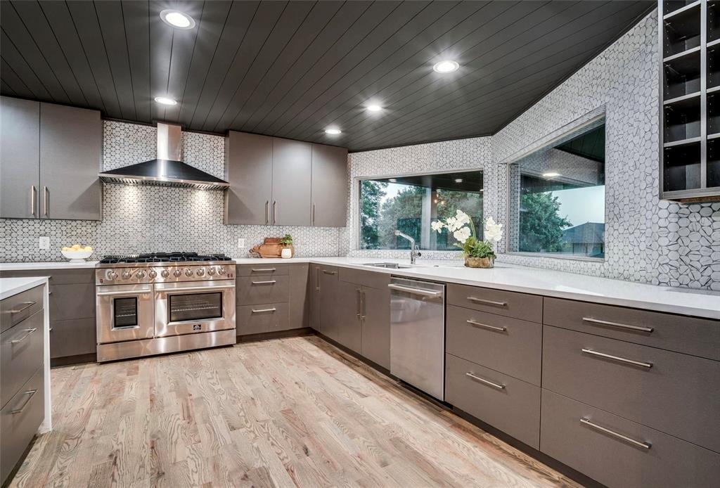 1408 South Alamo Road Rockwall, TX 75087 - Photo 12 of 40 a large kitchen with stainless steel appliances granite countertop a stove and a sink