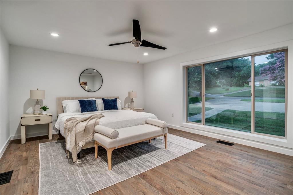 1408 South Alamo Road Rockwall, TX 75087 - Photo 16 of 40 a bedroom with a bed a window and table