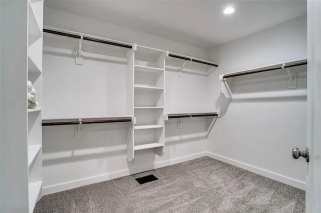 a spacious bathroom with a shower sink and mirror