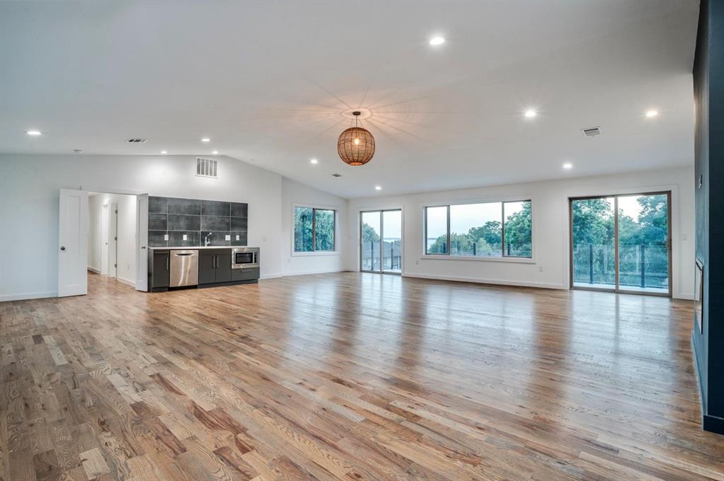1408 South Alamo Road Rockwall, TX 75087 - Photo 21 of 40 an empty room with wooden floor and windows