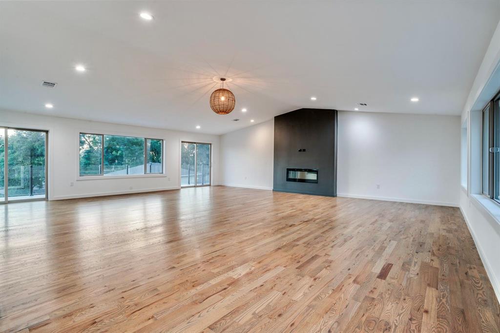 1408 South Alamo Road Rockwall, TX 75087 - Photo 23 of 40 an empty room with wooden floor and windows