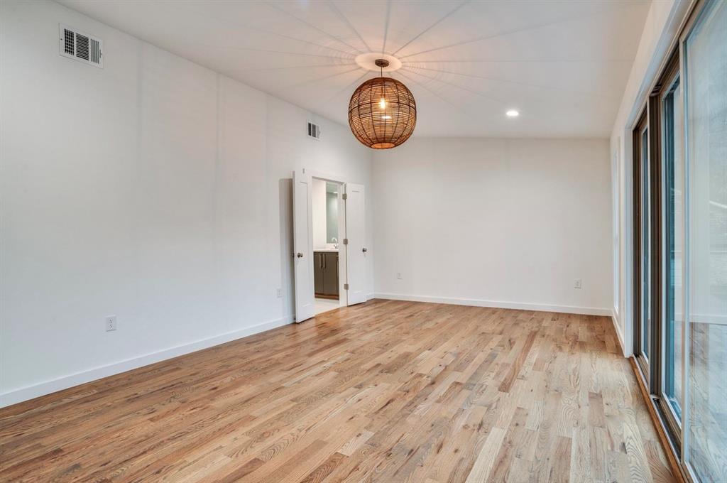 1408 South Alamo Road Rockwall, TX 75087 - Photo 25 of 40 a view of an empty room with wooden floor and a window