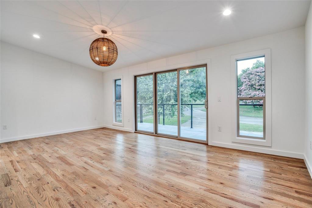 1408 South Alamo Road Rockwall, TX 75087 - Photo 29 of 40 a view of an empty room with wooden floor and a window