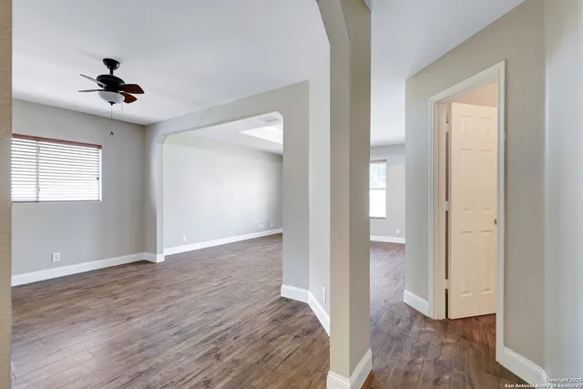 wooden floor in an empty room with a window