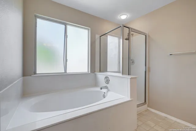 a bathroom with a bathtub and a shower